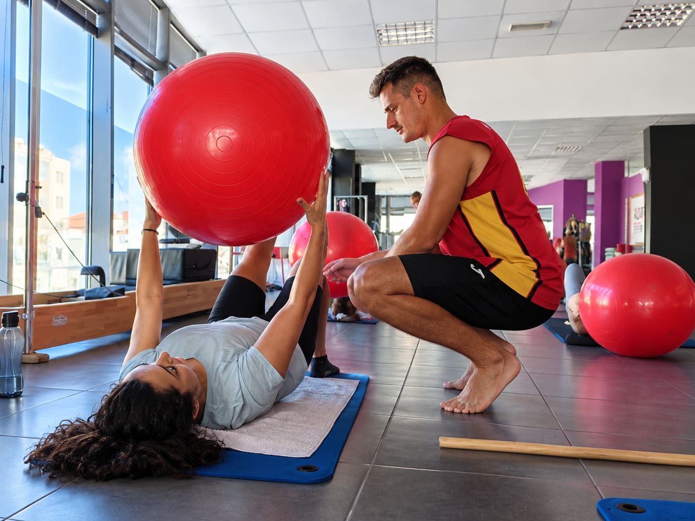 Esercizio di Pilates con fitball in sala corsi